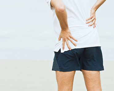 Pain-in-the-body-img-update person with hands on back experiencing pain